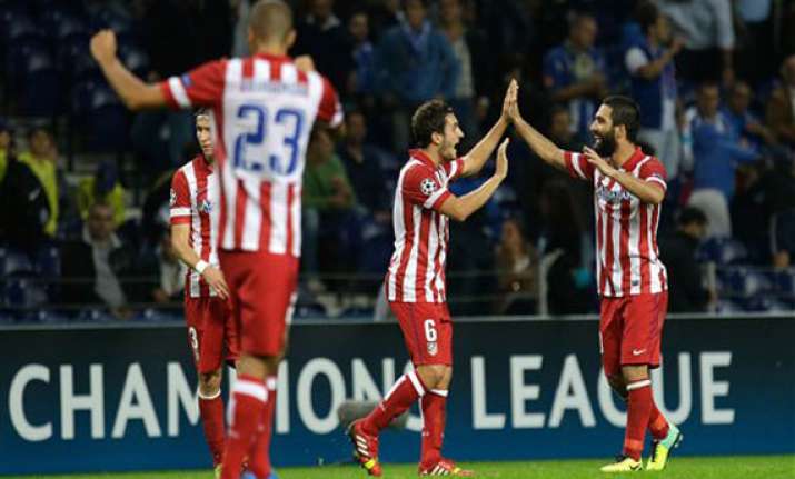 turan goal gives atletico madrid 2 1 win at porto