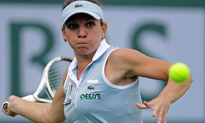 halep ousts defending champ vinci in barcelona