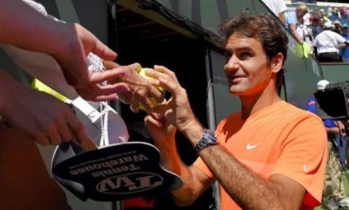 federer rolls nadal upset by raonic at indian wells