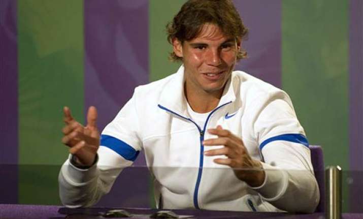 nadal says he is far from federer s grand slam record
