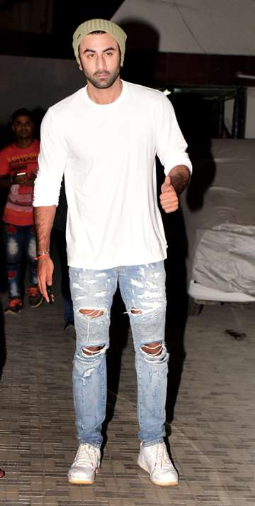 Ranbir Kapoor poses for paps in a white shirt and denims