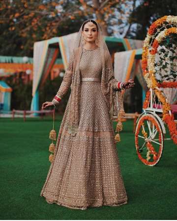 Day Wedding Lehenga Style | Chitrangada Singh | Dull yellow gold and light  pink Lehenga with allover embroidery, pink net dupatta | Tarun Tahiliani |  Curated by Witty Vows - Witty Vows