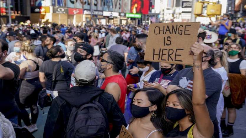 People celebrate in Times Square after former vice president and Democratic presidential candidate Joe Biden was announced as the winner over Pres. Donald Trump to become the 46th president of the United States, in New York. 