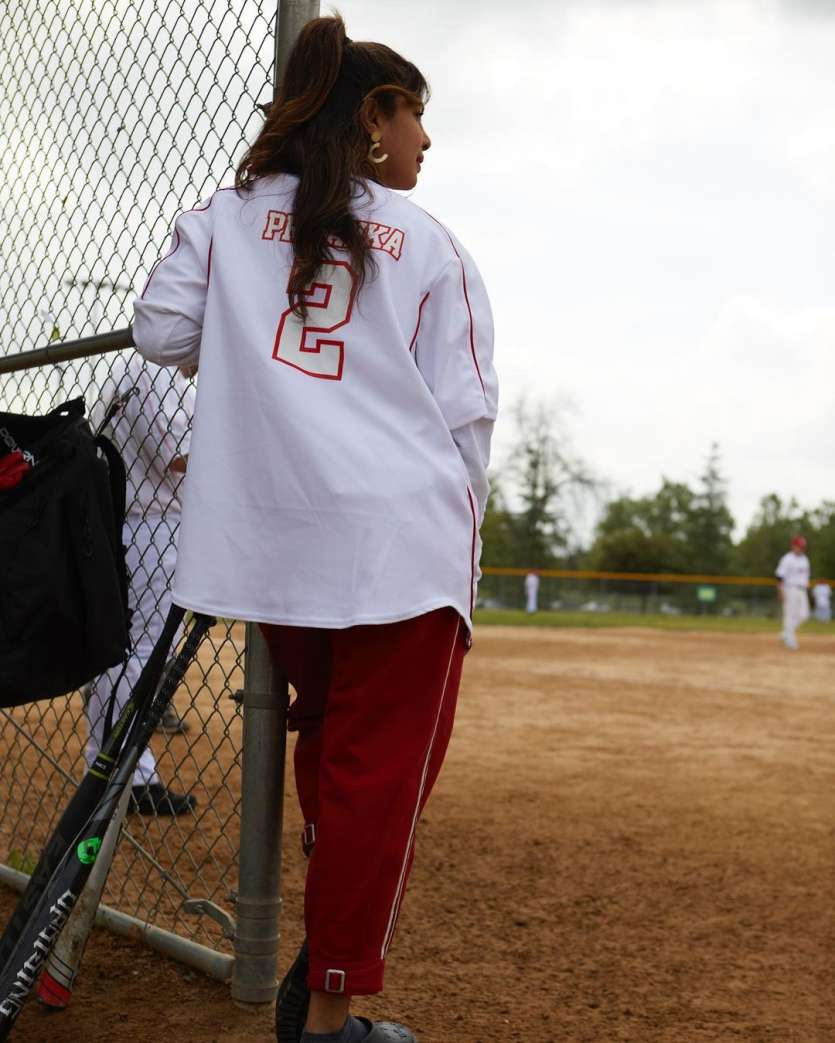 Priyanka wore an oversized white shirt which has her name printed on it, while she is cheering for her husband Nick Jonas.