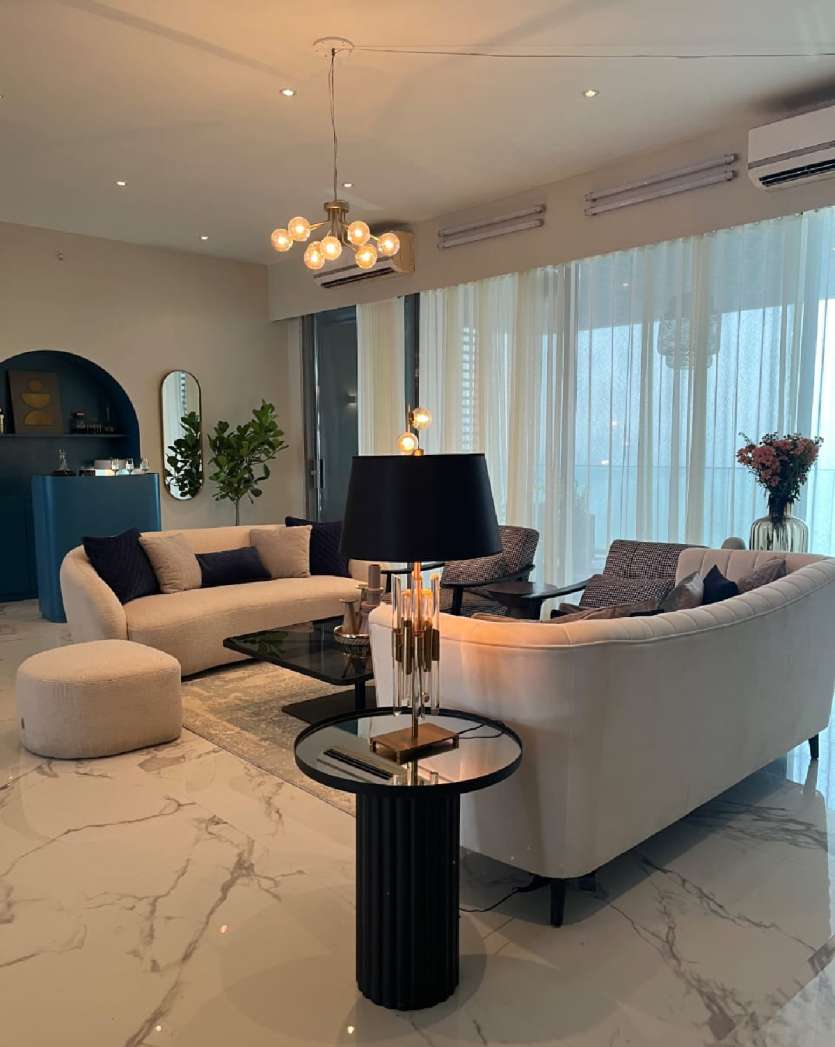 As for the living room. It is a vibrant space in shades of beige.  Comfy lounge chairs and a big sofa set look chic and neat. The curtains chosen by Malaika add more vibe to the room. Also, little detailing like a small chandelier and a green plant in the corner is striking.