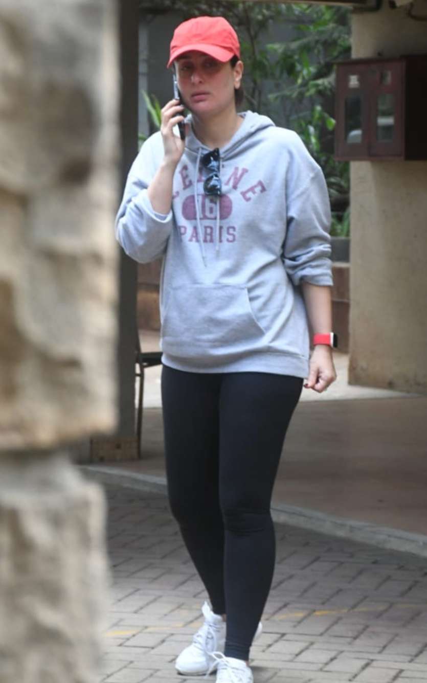 Kareena donned a grey hoodie and black yoga pants. She completed her casual look with a pinkish-red cap. She was on a call when the actress was clicked by the paps stationed outside her residence. 