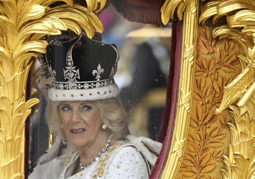 Queen Camilla waves to the crowds after the coronation ceremony in London.