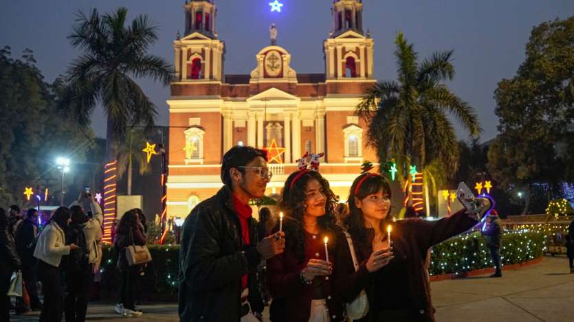 On Christmas, people gather at Sacred Heart Cathedral in New Delhi to click selfies, capturing the festive atmosphere. The beautifully lit cathedral serves as a popular backdrop for holiday memories.