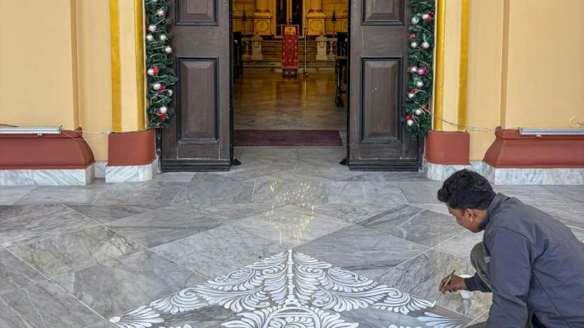 In Kolkata, traditional Aalpona designs are painted on the floor of a church as part of Christmas celebrations. The intricate artwork adds a festive touch, enhancing the spiritual ambiance of the church.