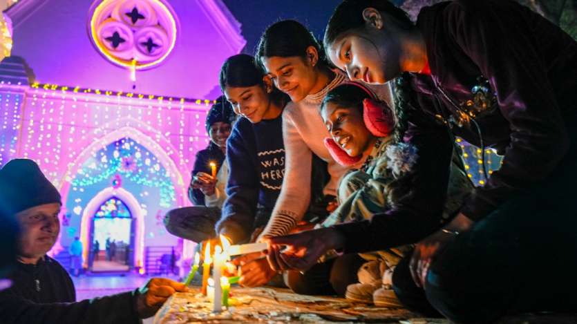 On Christmas, people gather at St. Paul's Church in Amritsar to light candles, celebrating the festive spirit. The church glows with warmth and joy as visitors participate in the cherished tradition.