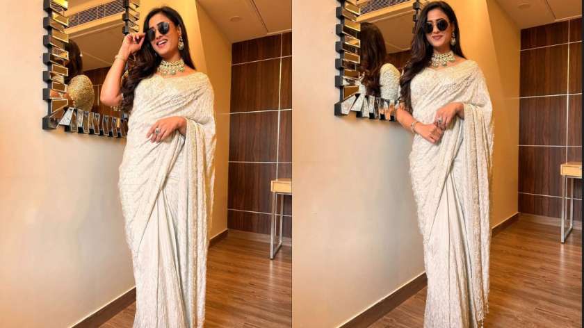 Wearing an embroidered ivory saree paired with statement green jewellery, Shweta breaks norms by styling sunglasses with her traditional look. Her confident pose proves that sarees and sunnies can make a chic combo.