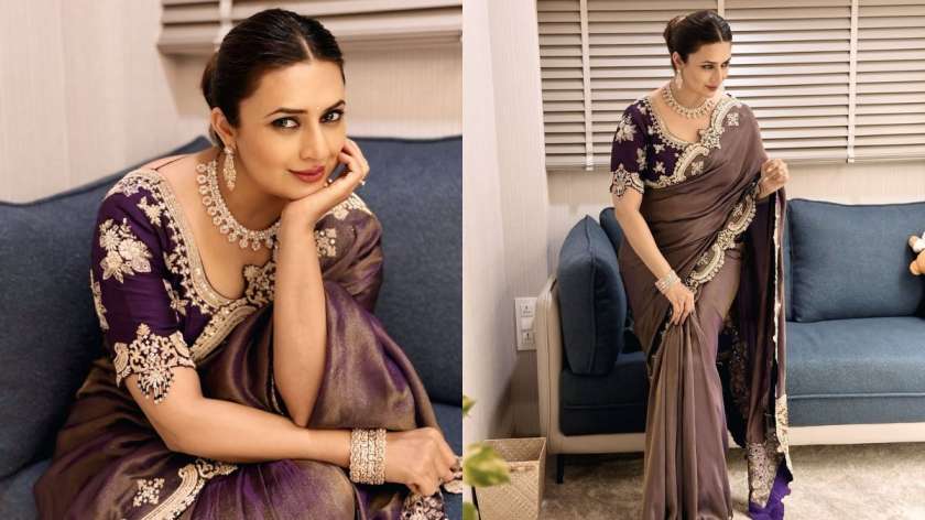 Divyanka stuns in a rich violet and gold saree with an intricately designed blouse. In one pose, she’s seated gracefully on a couch; in another, she stands poised with a sideways glance — both perfect for your next saree shoot.