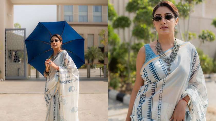 Surbhi keeps it cool in a white-and-blue cotton saree styled with silver jewellery and sunglasses. One image captures her laid-back vibe with shades on; in the other, she holds a blue umbrella, giving monsoon-summer shoot goals.