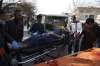 An injured man is moved on a stretcher outside a hospital