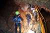 Thai rescue team members walk inside a cave where 12 boys