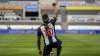 Newcastle's Allan Saint-Maximin takes a knee as he