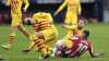 Barcelona's Gerard Pique, left, reacts after getting an