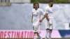 Real Madrid's Luka Modric and Karim Benzema, right, react