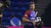 England's Jos Buttler smiles as he walks off the pitch