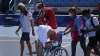 Paula Badosa, of Spain, is helped off the court in a