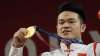 Shi Zhiyong of China celebrates on the podium after winning
