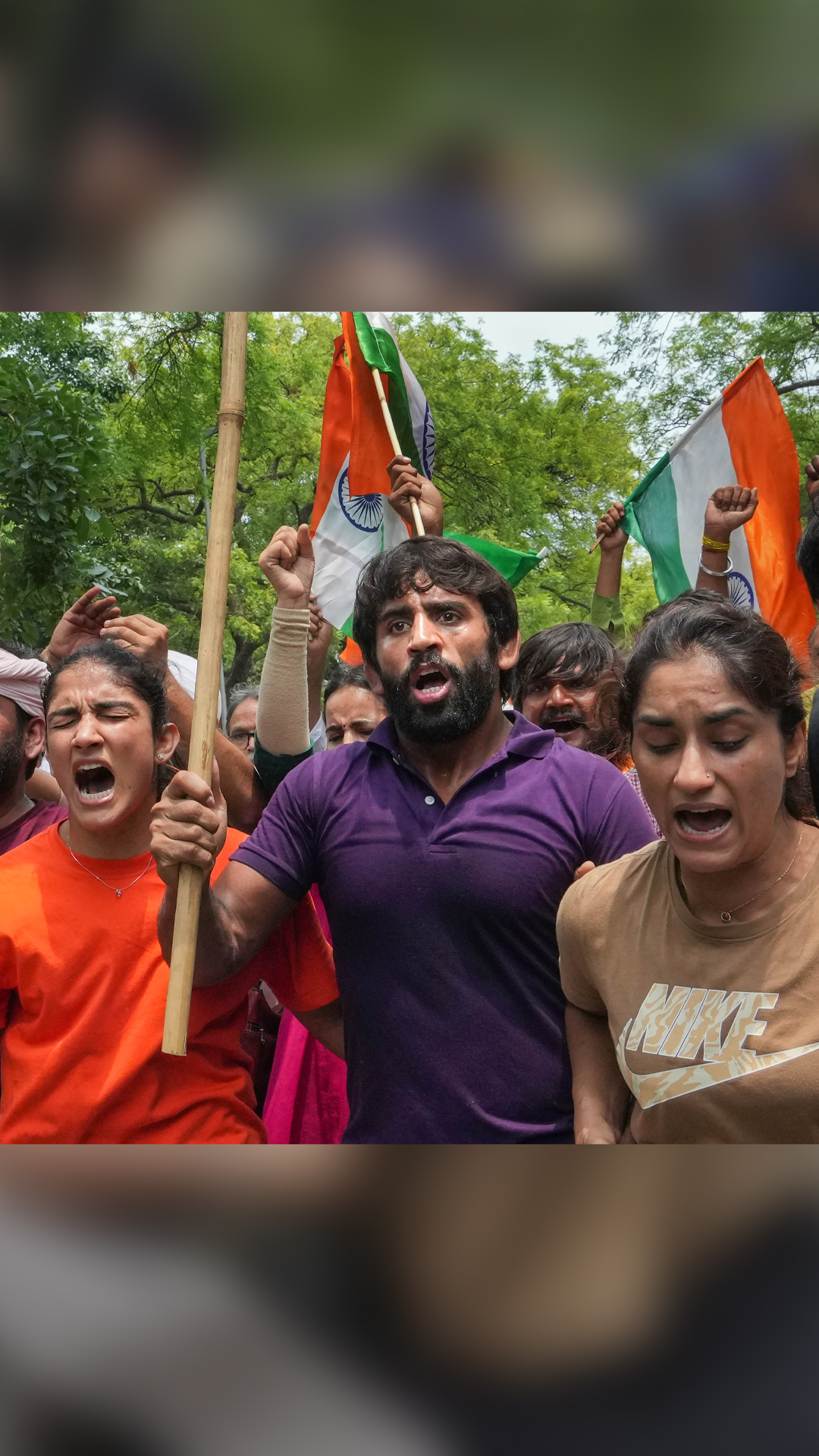 Wrestlers Vinesh Phogat, Sangeeta Phogat and Bajrang Punia with supporters during their protest march 