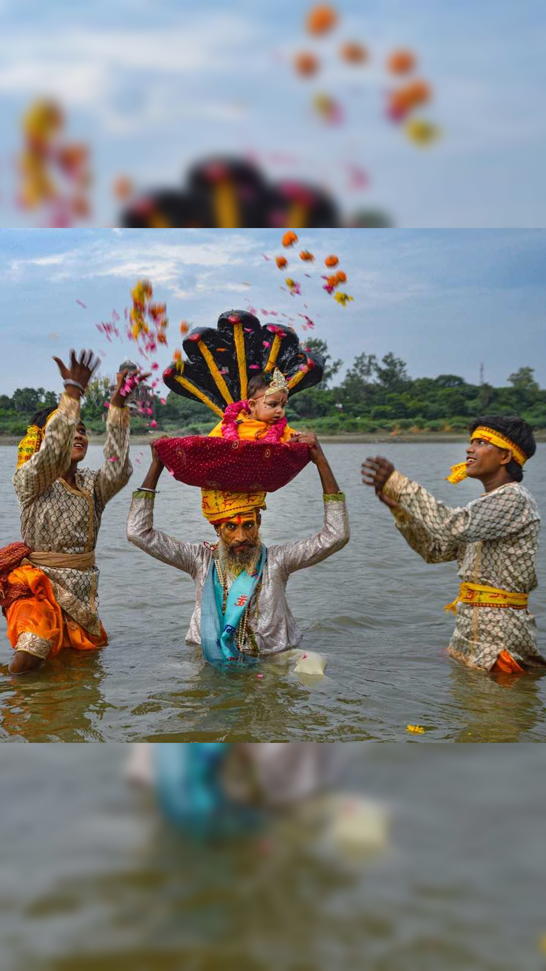 Devotees perform ritual as they take out tableau representing Lord Krishna's birth story in River Yamuna