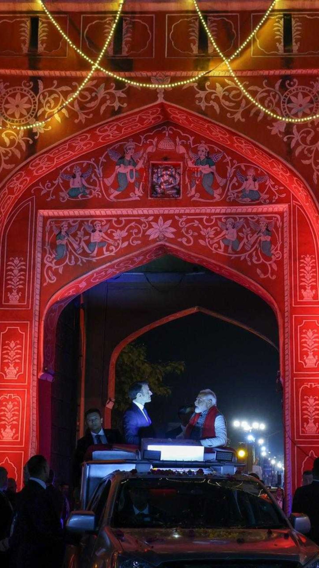 PM Modi and French President Emmanuel Macron during a roadshow, in Jaipur