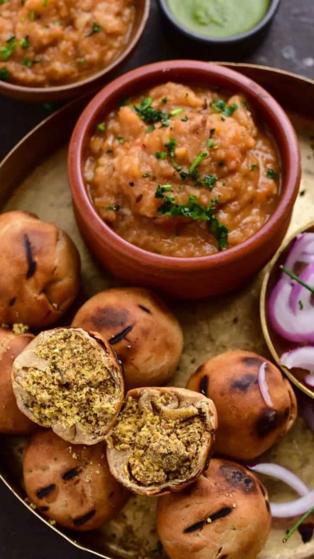 Litti Chokha: A quintessential Bihari dish, litti chokha consists of roasted wheat balls stuffed with sattu (roasted gram flour) and served with a spicy side of mashed potatoes, tomatoes, and eggplant.