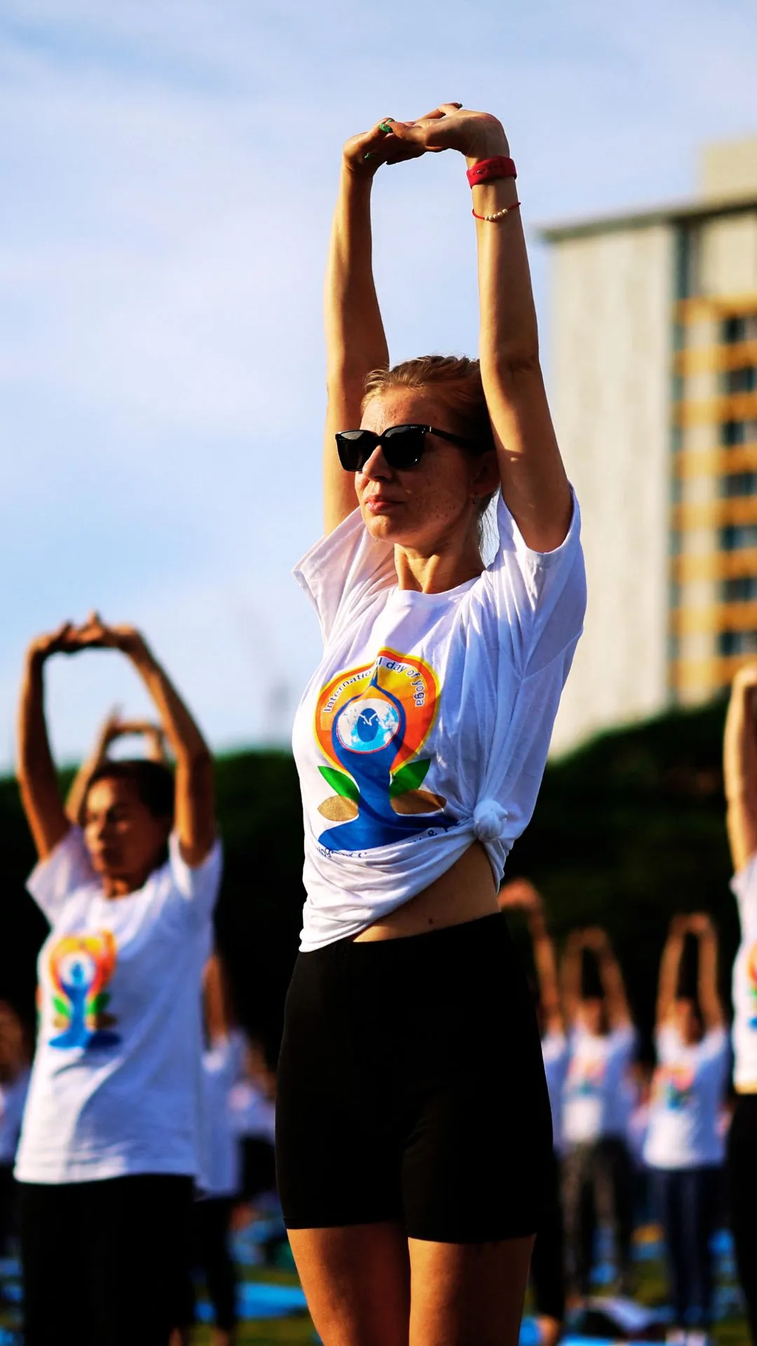 People attend a mass yoga session ahead of the 10th International Yoga Day, in Bangkok, Thailand