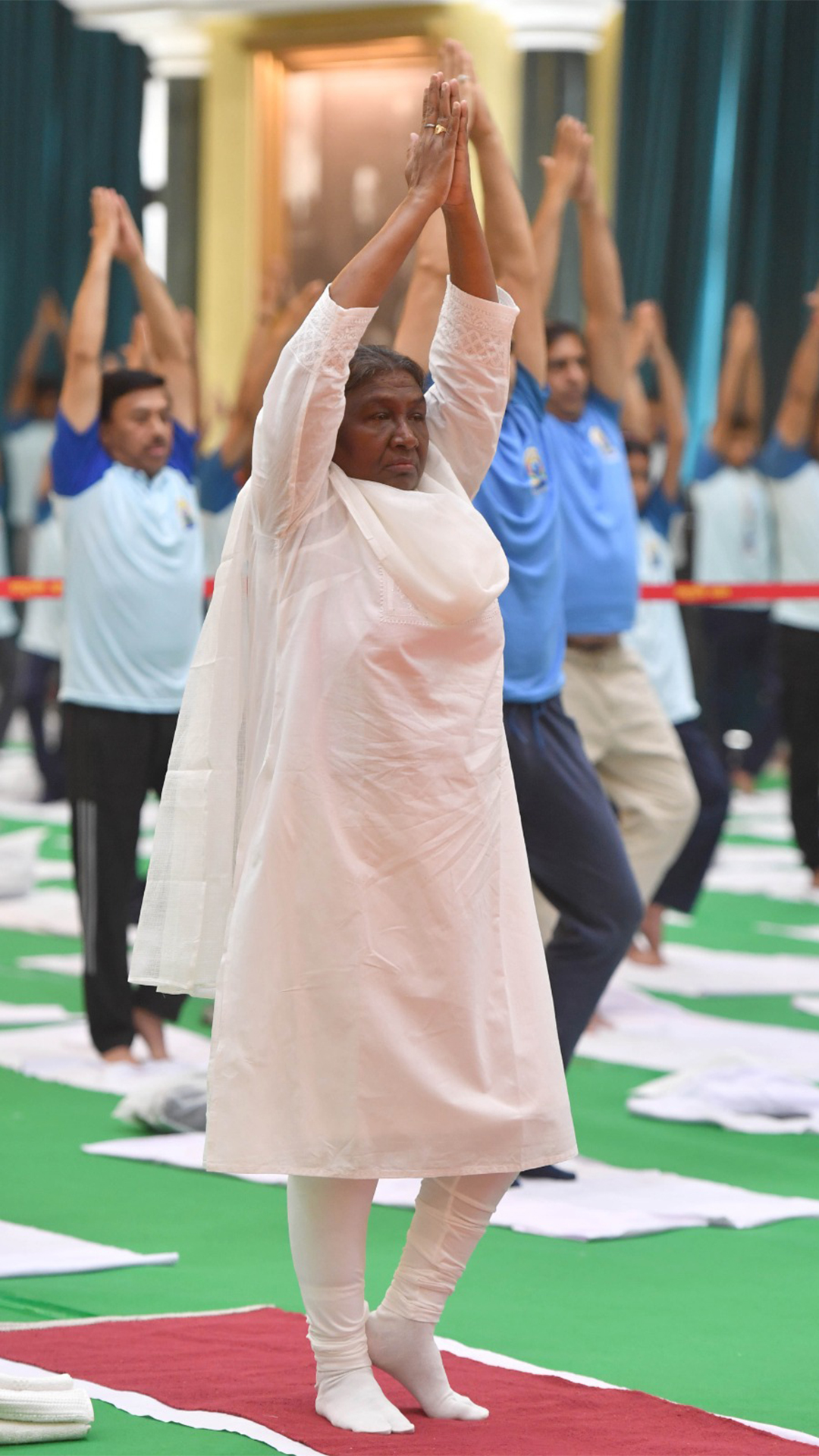 President Droupadi Murmu performs yoga with others at the Rashtrapati Bhavan