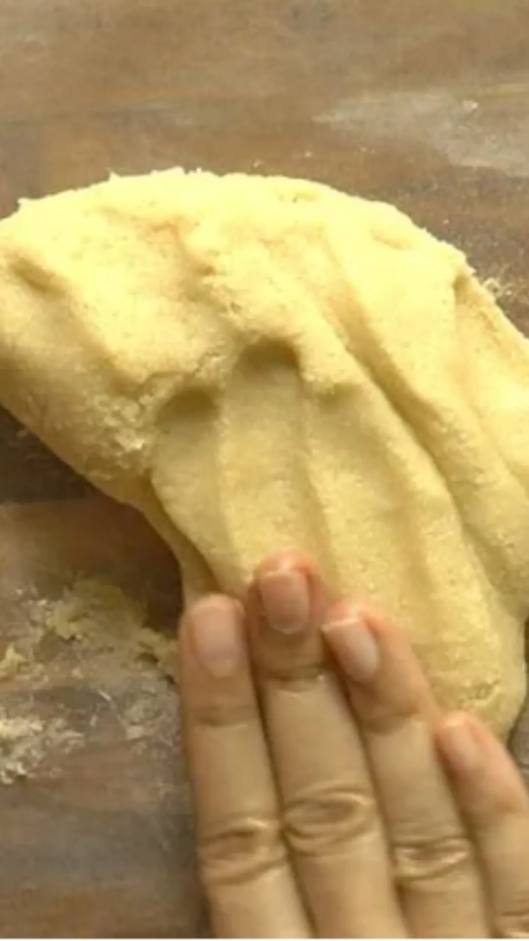 Take a greased butter paper and transfer the dough into it. Knead a few times until it turns soft. 