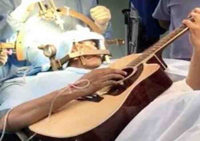 Bengaluru man playing guitar while doctors perform a brain surgery on him