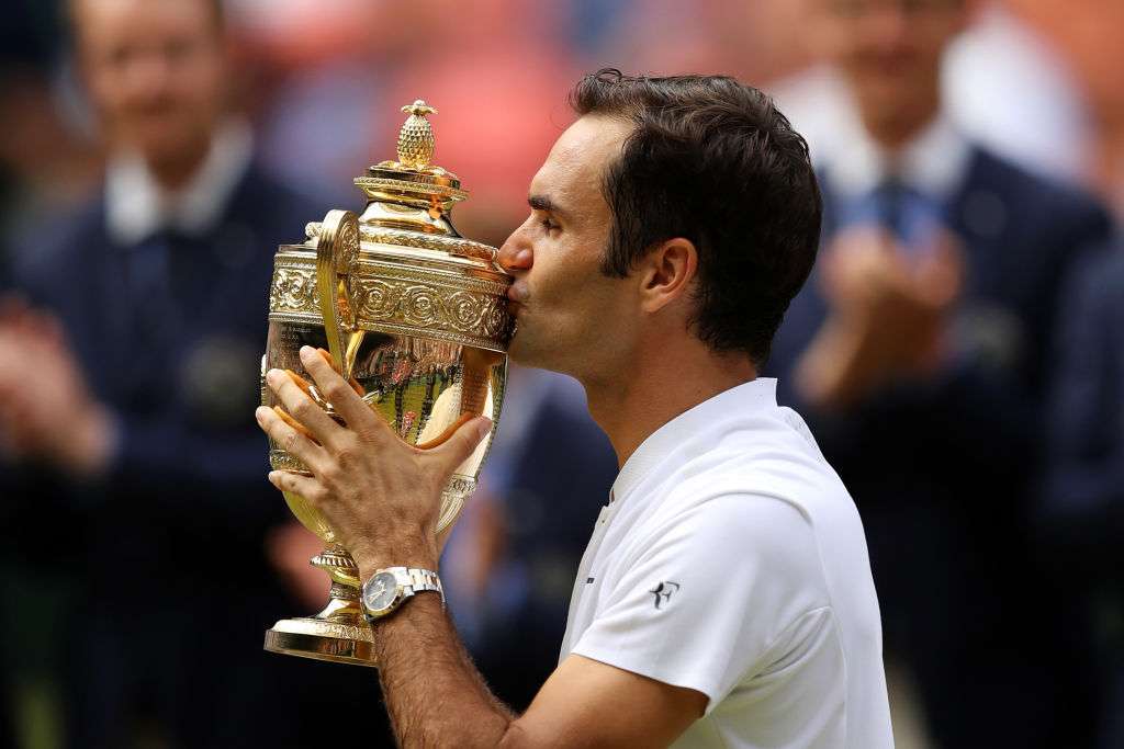 Roger Federer of Switzerland kisses the trophy after the victory