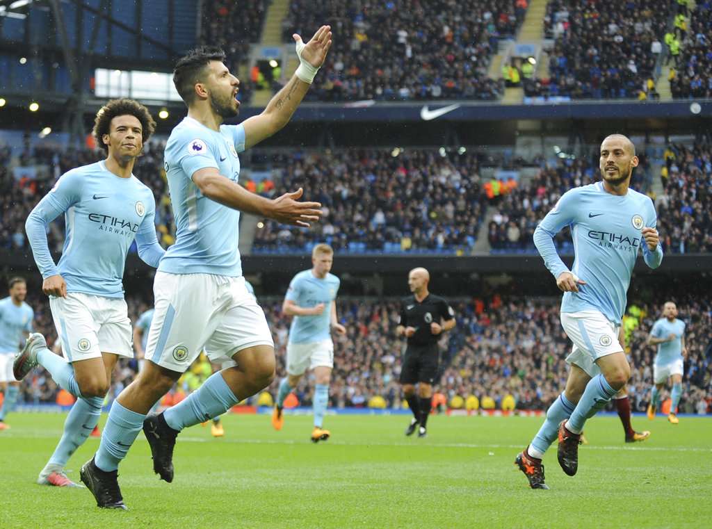 Manchester City players celebrate after scoring a goal against Burnley.