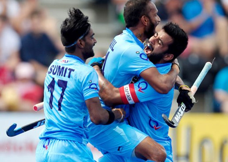 Maninder Singh celebrates a goal with his teammates