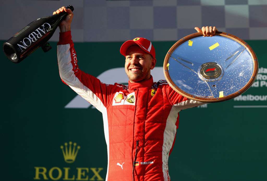 Sebastian Vettel poses with the trophy after winning the Australian GP