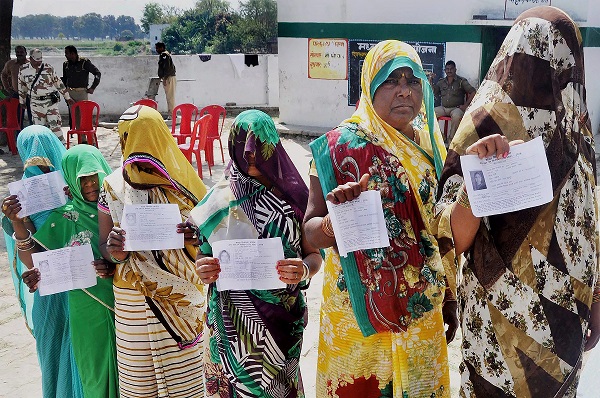 Allahabad: Voters display their voter's ID card at a polling booth for Phulpur bypoll elections in Allahabad on Sunday