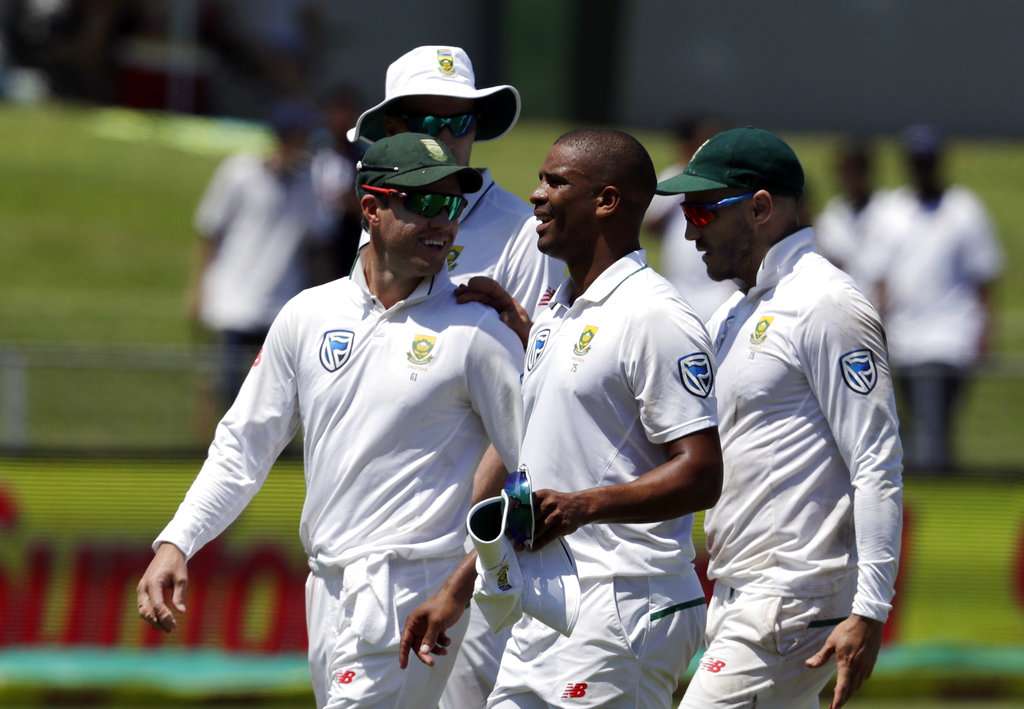 Vernon Philander flanked by teammates AB de Villiers and captain Faf du Plessis after bowling out David Warner on day one of the first Test