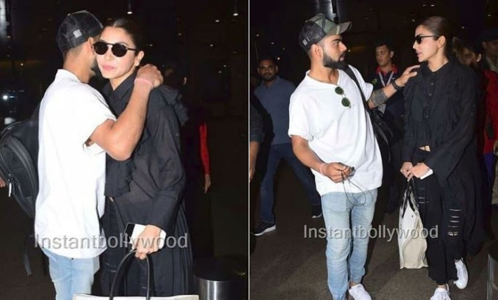 Anushka Sharma poses with Virat Kohli to the paparazzi at the Mumbai  airport Media