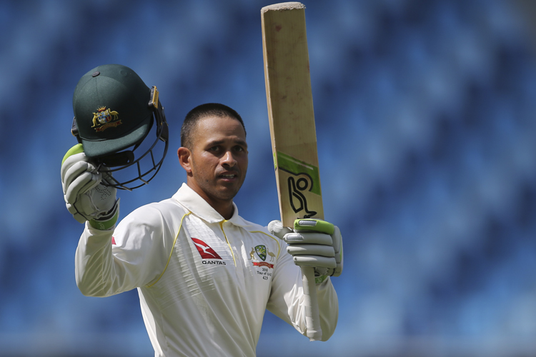 Usman Khawaja celebrates his century during their test match against Pakistan in Dubai.