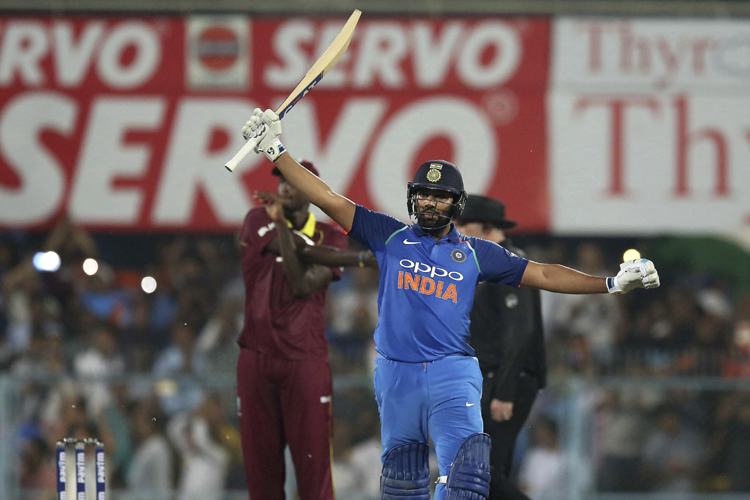 Rohit Sharma celebrates after scoring a century against West Indies in the first ODI at Guwahati.