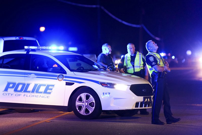 Authorities direct traffic on Hoffmeyer Road near the Vintage Place neighborhood where several law enforcement officers were shot, one fatally, on Wednesday