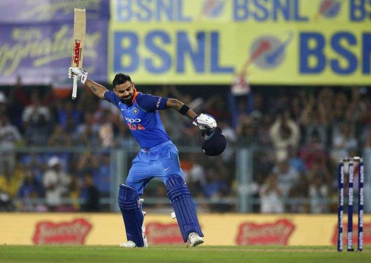 Virat Kohli celebrates after scoring a century