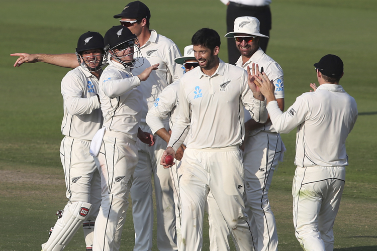 Will Somerville and teammates celebrate the dismissal of Pakistan's Yasir Shah in Abu Dhabi.