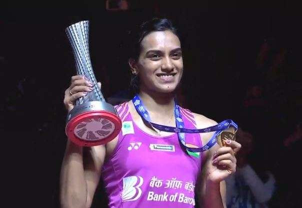PV Sindhu poses with the trophy and medal after winning the World Tour Finals