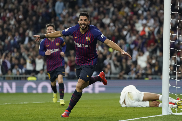 Luis Suarez celebrates after Real defender Raphael Varane scores an own goal during the Copa del Rey semifinal