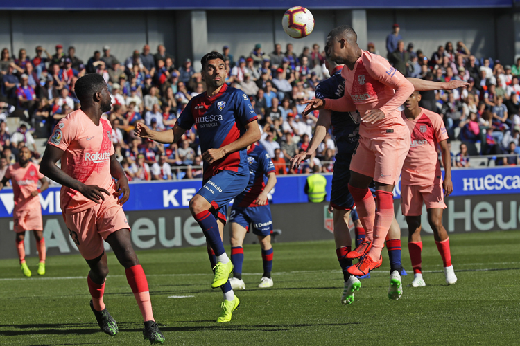 Barcelona's Malcolm Oliveira, right, heads the ball during the Spanish La Liga soccer match against Huesca.