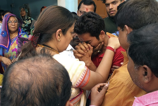 BJP MP Smriti Irani consoles the family members of former village head (pradhan) Surendra Singh