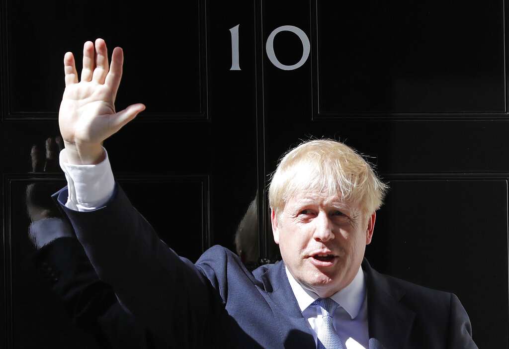 UK PM Boris Johnson moves at Downing Street along with his girlfriend